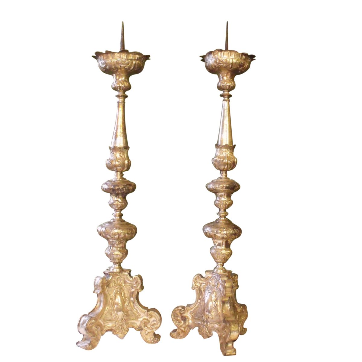 A pair of late baroque silvered brass altar candlesticks, first
